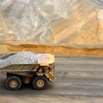 Earth AI’s algorithms found critical minerals in places everyone else ignored A large yellow dump truck carries ore out of a pit mine.