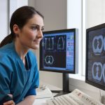 In Harvard study, AI offered more accurate emergency room diagnoses than two human doctors Doctor looking at x-rays from CT-scanner on computer